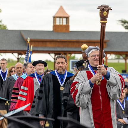 Faculty Senate walking to commencement in official robes