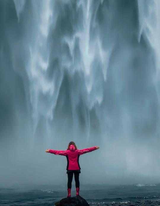 International Student in front of waterfall