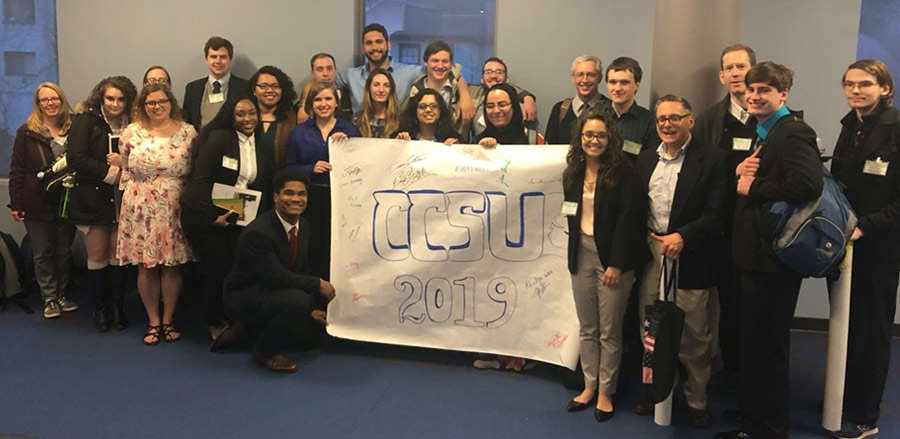 Group of students with handwritten "CCSU 2019" sign