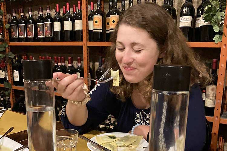 female student eating ravioli