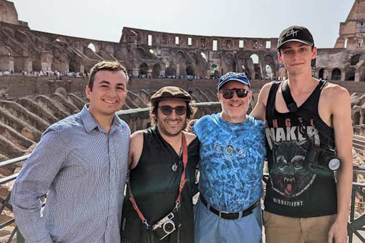 4 students in front of colosseum
