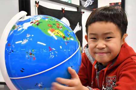 Small Child Holding Globe