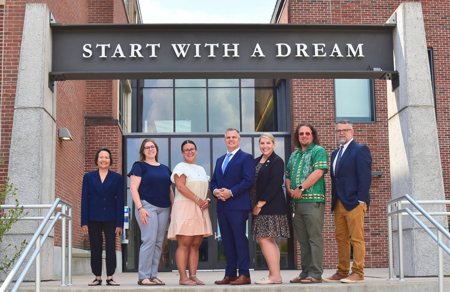 School of Education Dean's staff in front of entryway labeled Start with a Dream