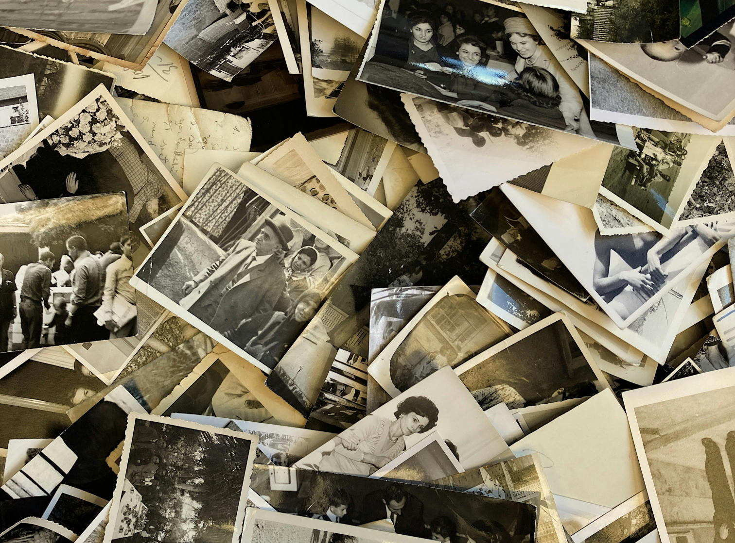 A pile of black and white photographs