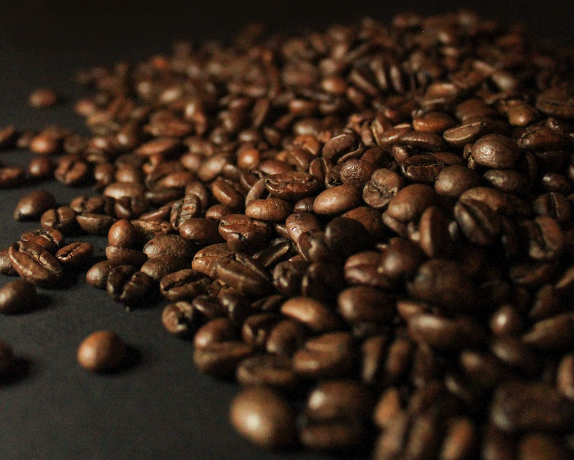 Closeup of coffee beans against a black background