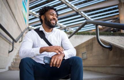 Male student sitting on steps