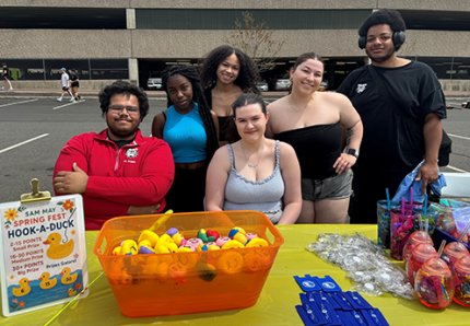 IRC members in front of a table sale 