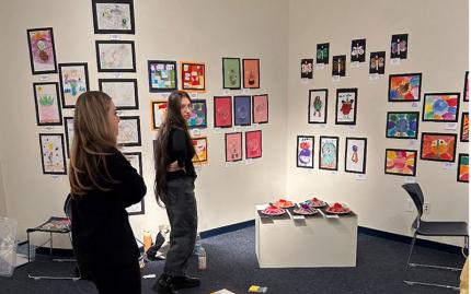 Art & Design two students looking at art