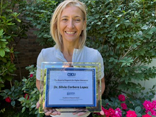 Photo of Dr. Silvia Corbera Lopez with award