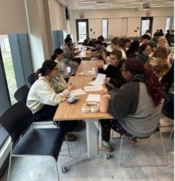 ASL Class sitting at a long table 