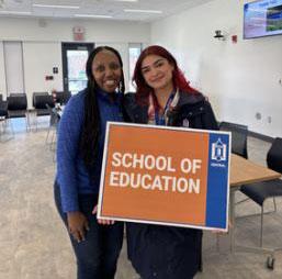 Students holding School of Education sign