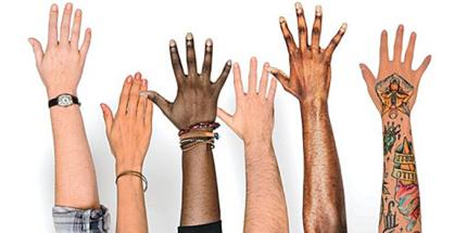 Raised hands of varying ethnicities