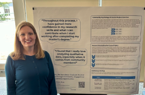 Dr. Holly Brott standing in front of Psychology poster