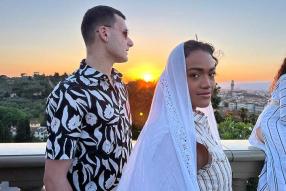 male and female student in front of sunset