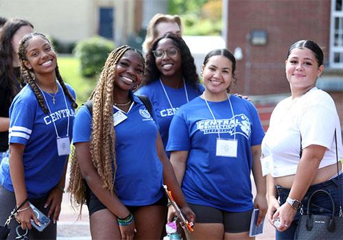 5 open house student guides outside