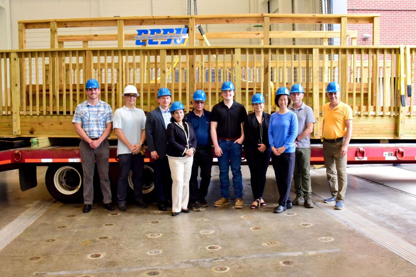 Group photo after a timber bridge ceremony in the Applied Innovation Hub