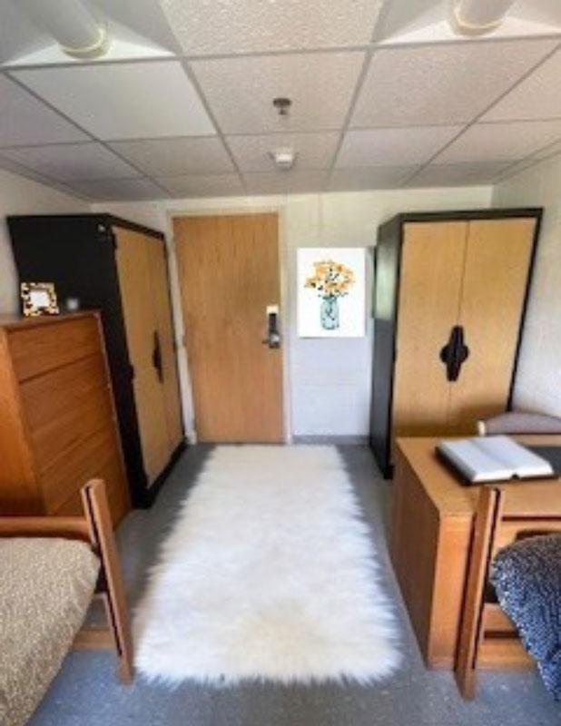 Dorm room with 2 beds and 2 closets