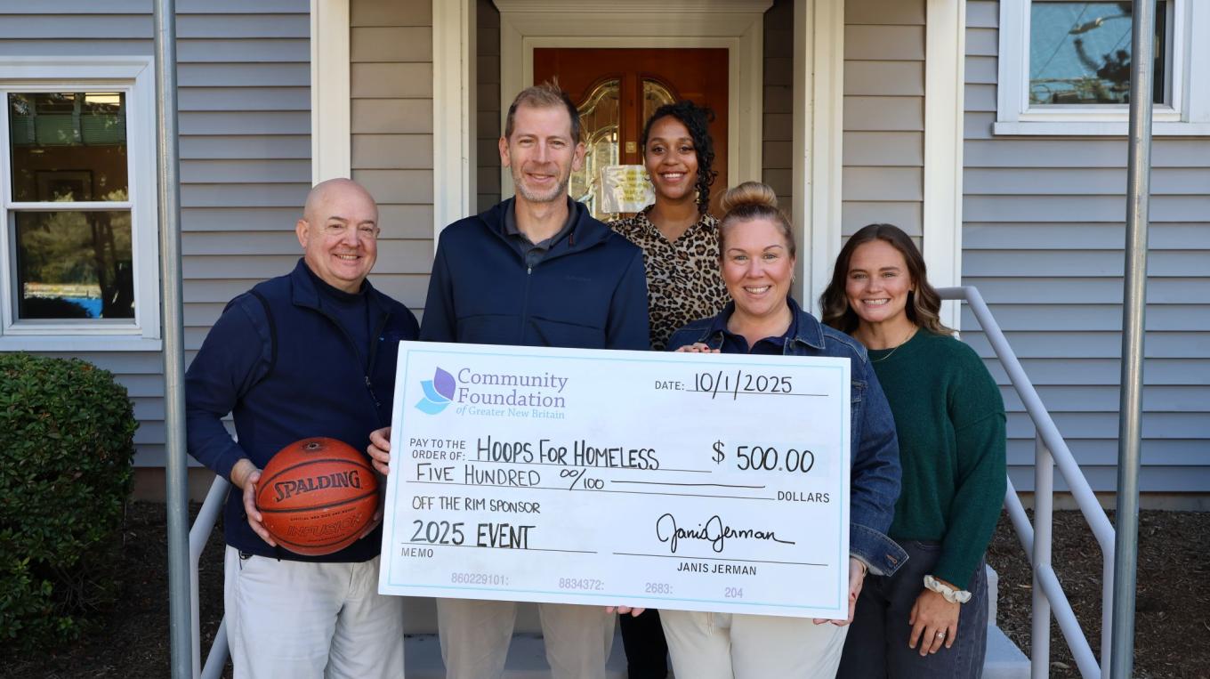 Hoops for Homeless founders hold up a ceremonial donation check