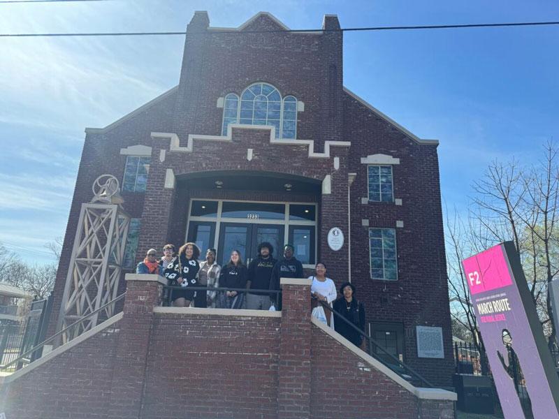 Students on stairs in front of building