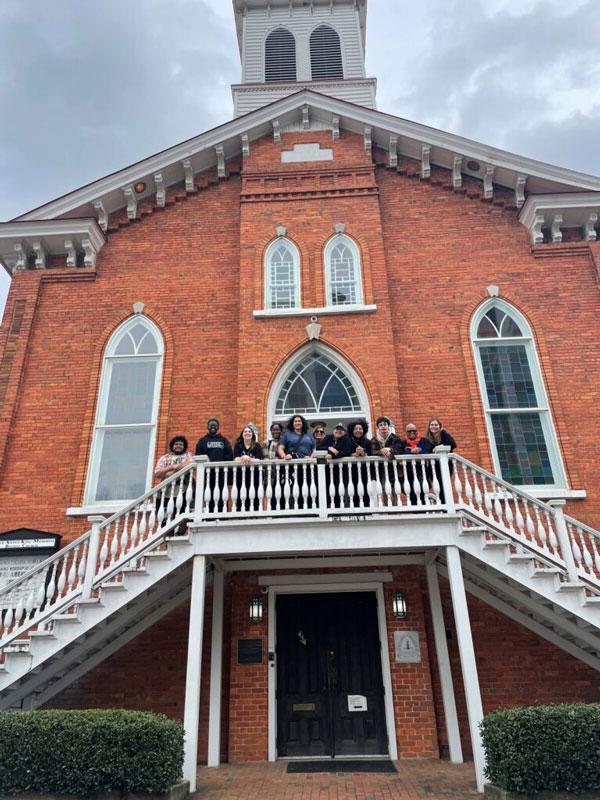 Students on stairs in front of building