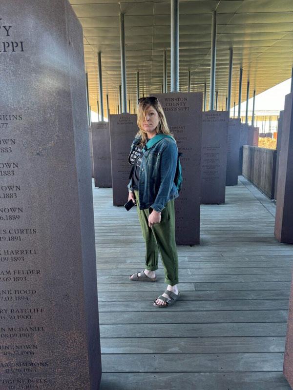 person standing near walls with names