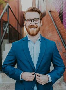 portrait of Even Krawiec in front of stairs