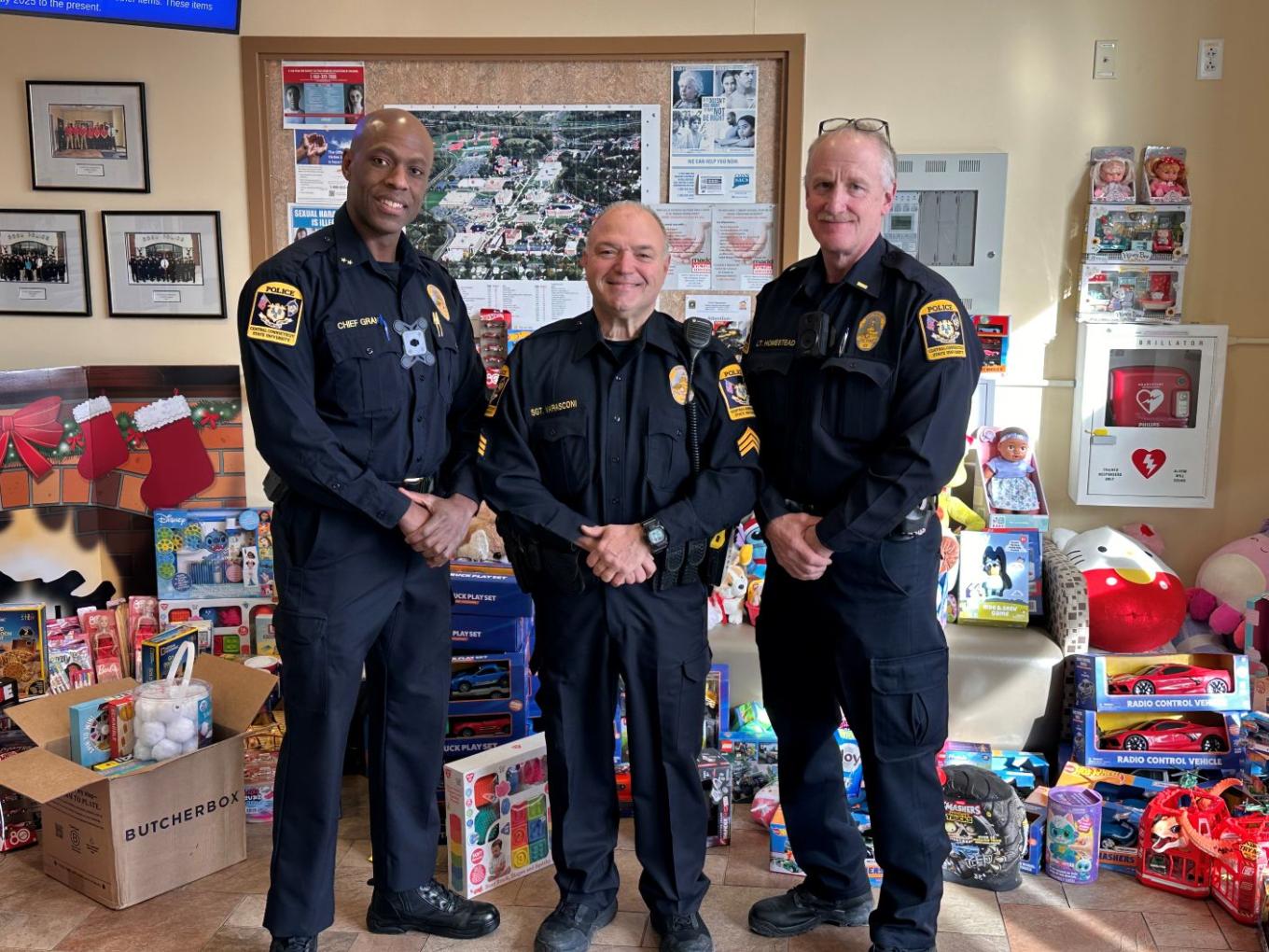 CCSU Police officers pose with toy donations in the campus police department lobby.