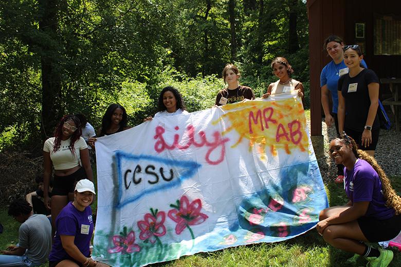 Group photo with a central crafted flag