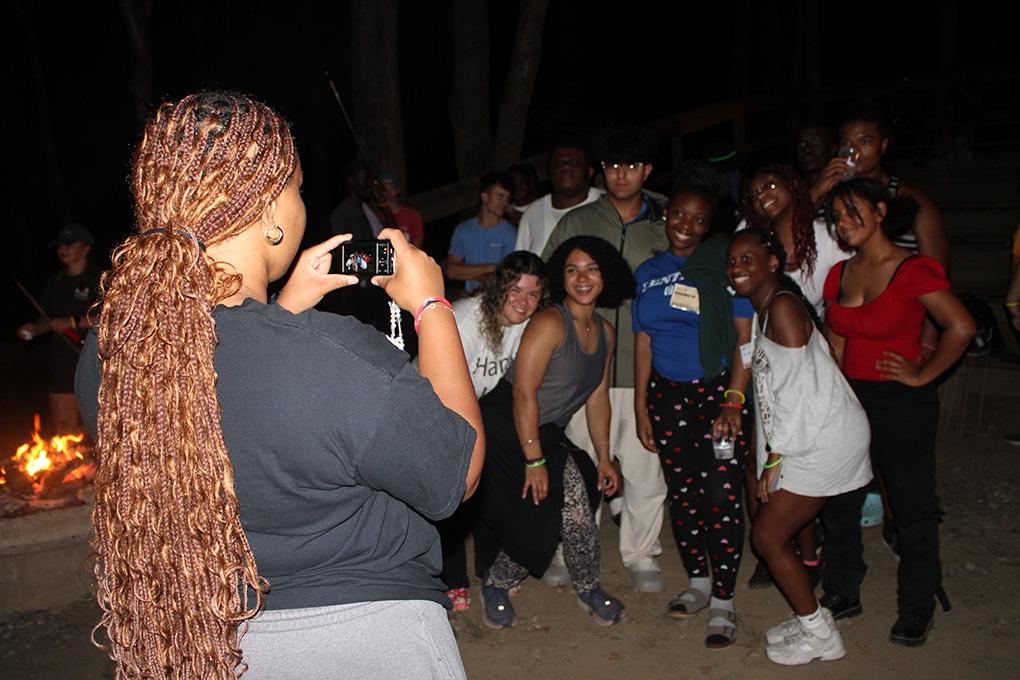 Group photo next to a bonfire