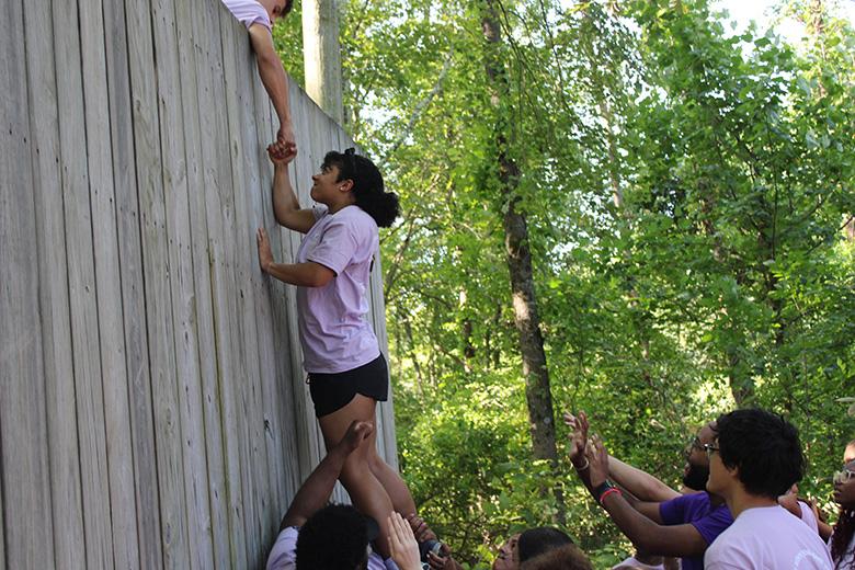 Group climbing exercise over a wall