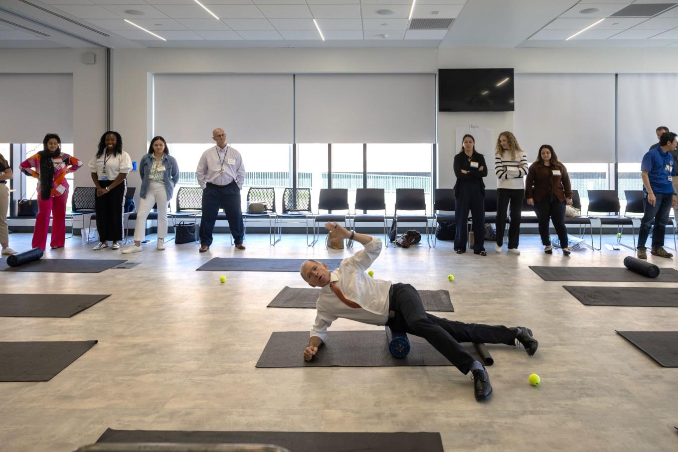 Mike Ryan demonstrates a foam roller exercise at Barnard Hall.