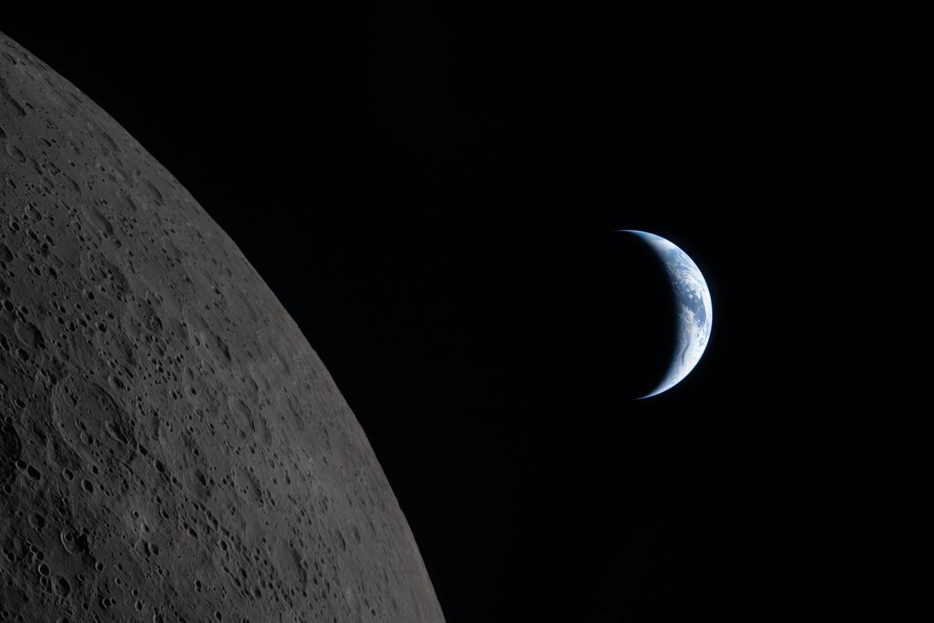 Earth draws closer to passing behind the Moon in this image captured by the Artemis II crew during their lunar flyby, about six minutes before Earthset. Earth is in a crescent phase, with sunlight coming from the right. (Image courtesy of NASA)