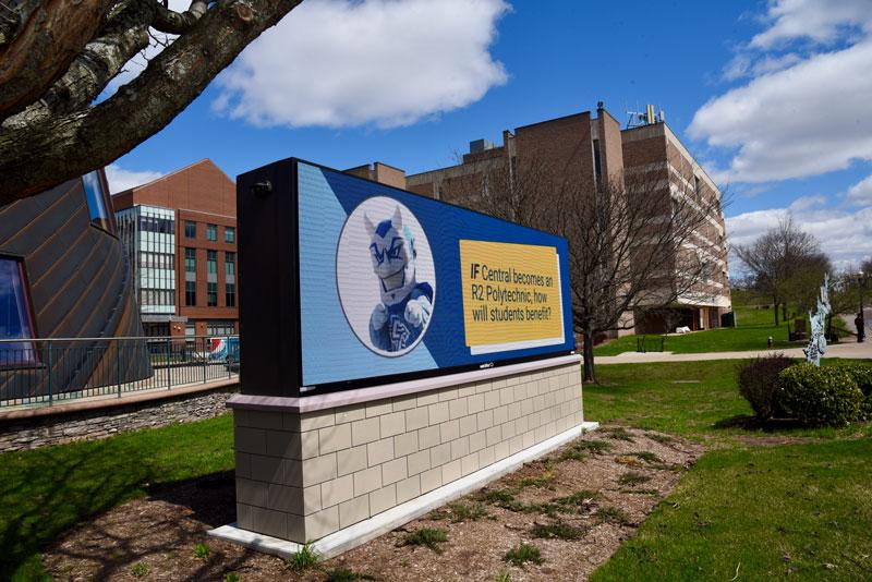 Outdoor signage featuring Polytech info and Kizer