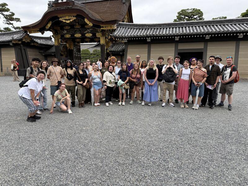 Central students and faculty take a group photo outside of a temple in Japan.