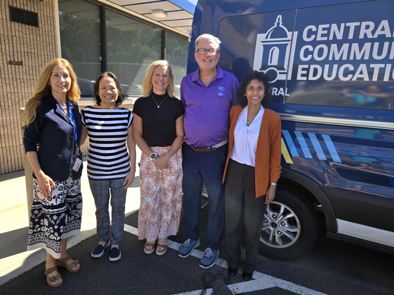 (From left) Associate Director of Leadership Giving Melody Avery; Dr. Helen Abadiano, interim associate dean of the College of Health and Rehabilitation Sciences; Dr. Lisa McMahon, Central Community Health Education Clinic coordinator; Dr. William Petit, president of the Petit Family Foundation; and Dr. Jayanthi Kandiah, dean of the College of Health and Rehabilitation Sciences, are shown outside of the clinic with the mobile unit in the background.