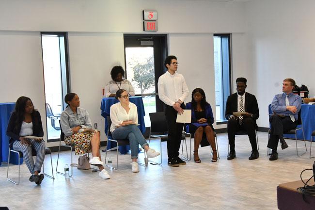 Group sitting at opening of John Lewis Institutes
