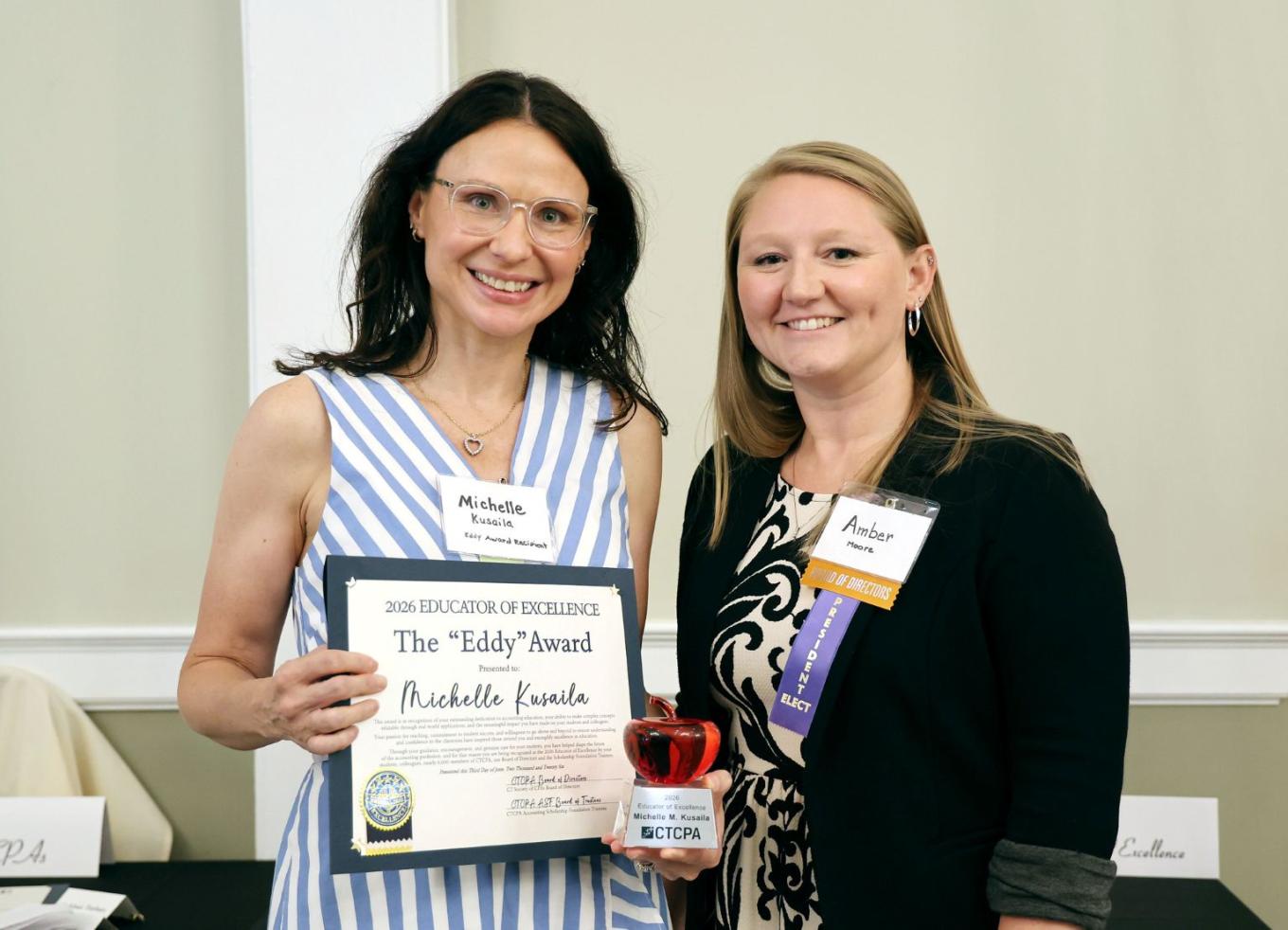 Professor Michelle Kusaila (left) accepts the 2026 Educators of Excellence Award from CTCPA Chair-elect Amber Moore of Goldblatt Bokoff.
