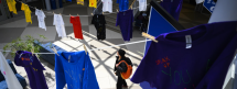 Student walking through hall with supportive message shirts hanging