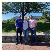 group of three graduate interns posing outside