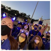 Group of interns wearing blue devil horns