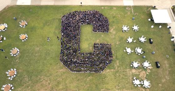 Drone photo of students in the shape of a C on Vance lawn.