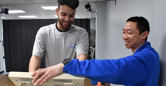 A student athlete and Athletic Training faculty member work together on a treadmill.