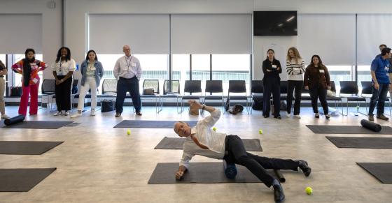 Mike Ryan demonstrates a foam roller exercise at Barnard Hall.