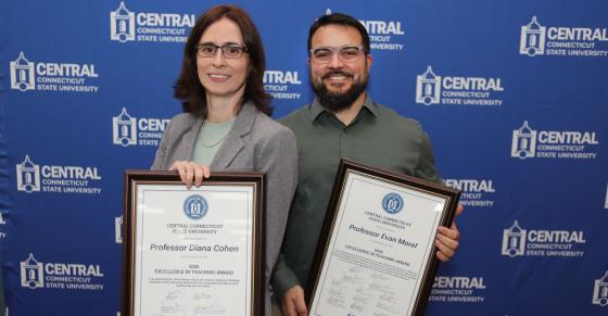 EIT winners Dr. Diana Cohen (Political Science) and Evan Morel ’14 (Engineering) stand against a Central branded backdrop.