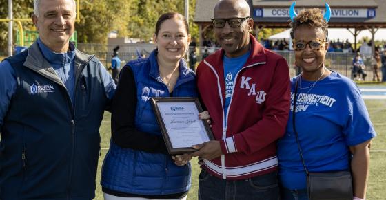Central COO Sal Cintorino, Interim President Kimberly Kostelis, Larry Hall, and Persephone Hall are shown here on the football field at Central.