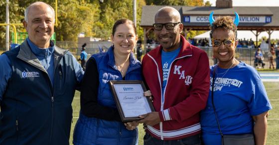 Central COO Sal Cintorino, Interim President Kimberly Kostelis, Larry Hall, and Persephone Hall are shown here on the football field at Central.