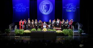 Campus leadership on stage at winter commencement