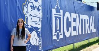 Emily Ramirez stands in front of her scrim design