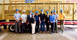 Group photo after a timber bridge ceremony in the Applied Innovation Hub