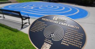 Signage in front of the Central Meditative Labyrinth explains the benefits of walking meditation.